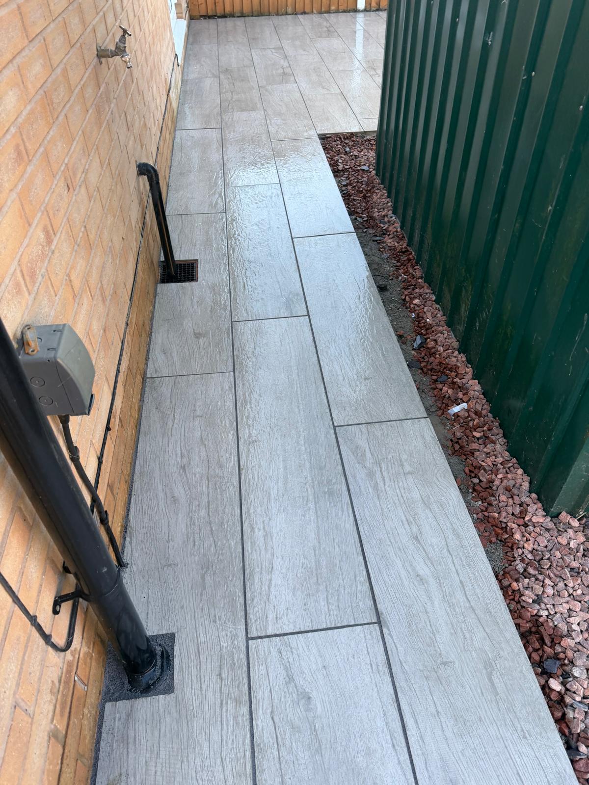 New tile path beside fence
